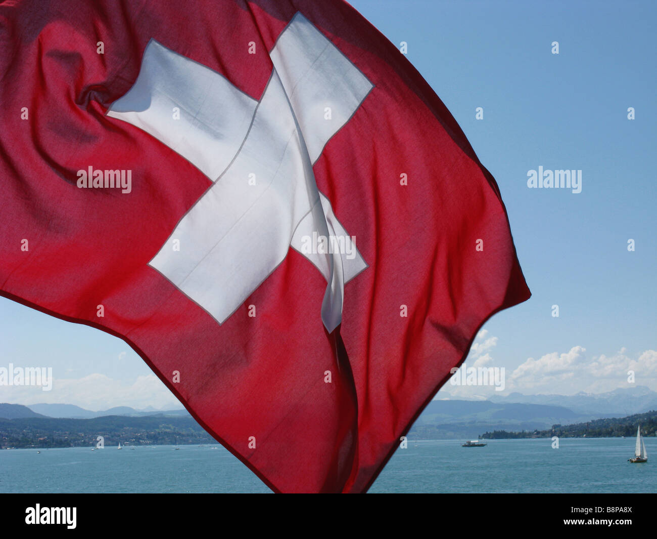 swiss ensign blowing in the wind Stock Photo Alamy