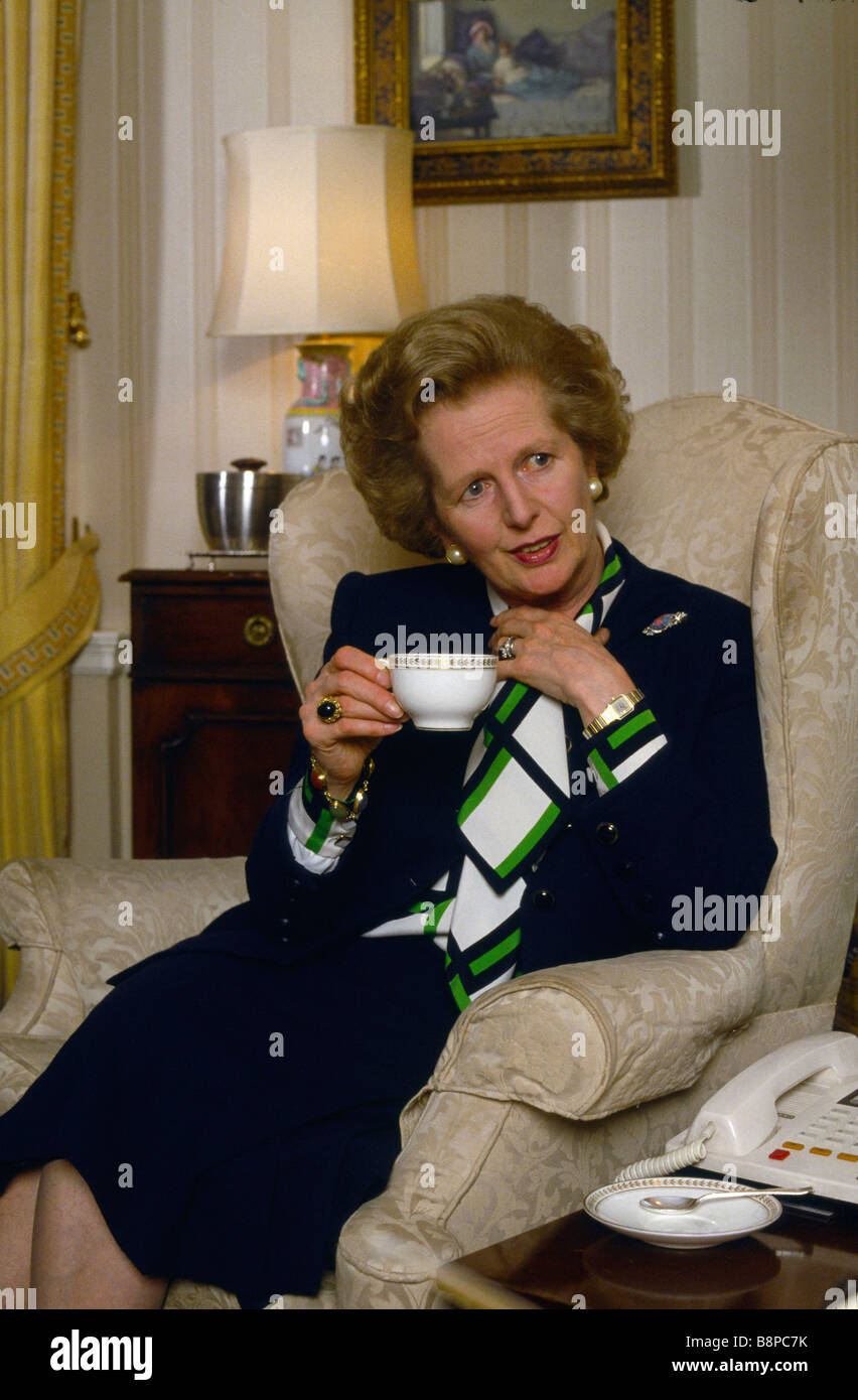 British Prime Minister Margaret Thatcher drinks tea private session in her drawing room in 10 Downing Street 1980s Stock Photo