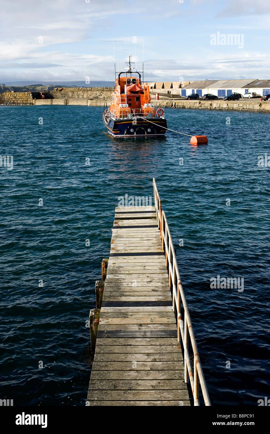 Gangway in Portrush Harbour and distant lifeboat Stock Photo