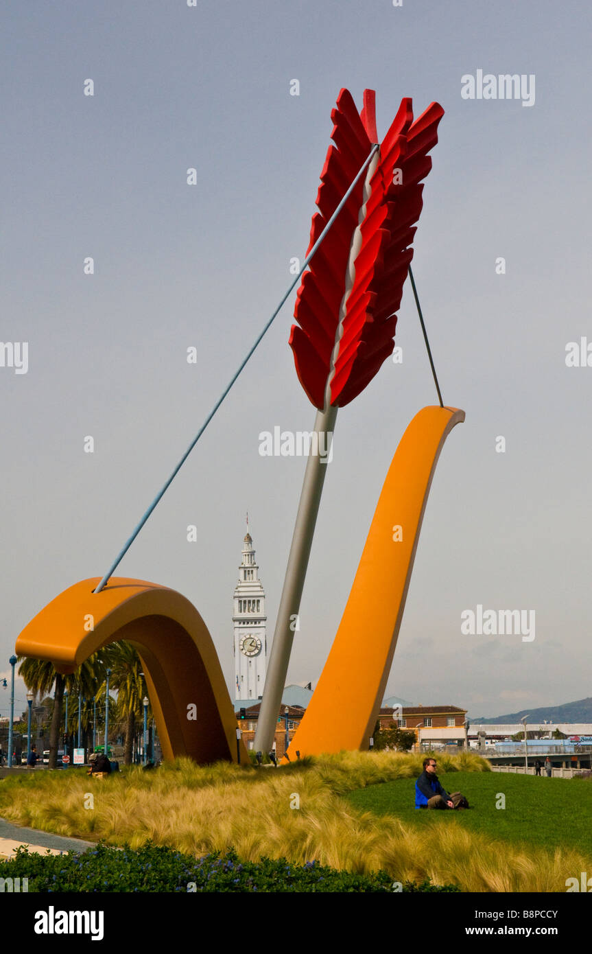 Large sculpture in Rincon Park of bow and arrow with Ferry Building Tower in background Stock Photo