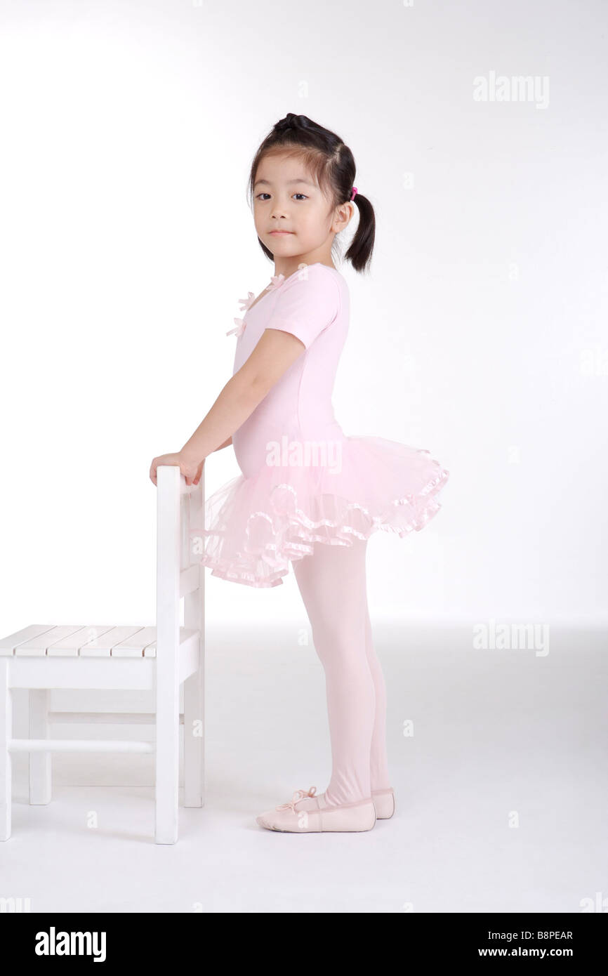 Girl ballet dancing with chair side view portrait Stock Photo