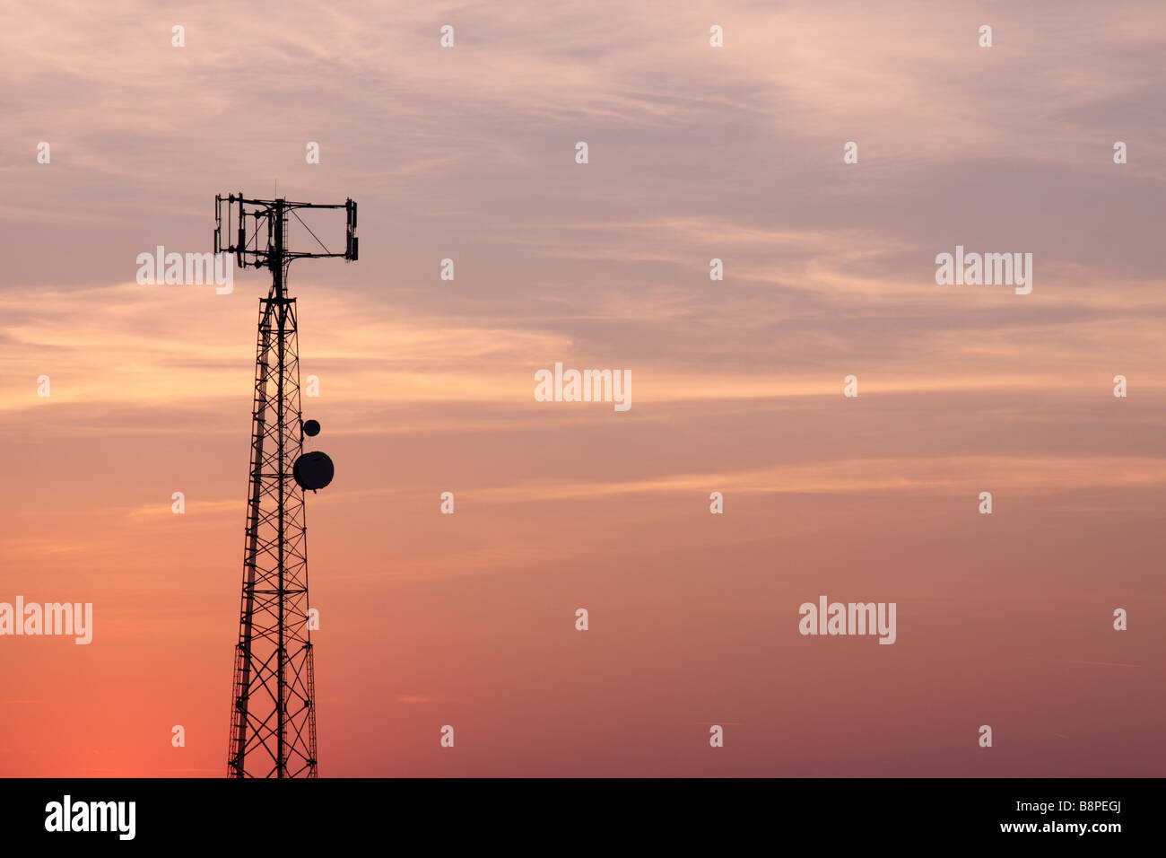 Orange-Pink Cell Phone Tower Silhouette Stock Photo
