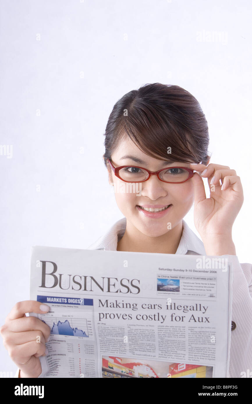 Young businesswoman with glasses holding newspaper Stock Photo - Alamy