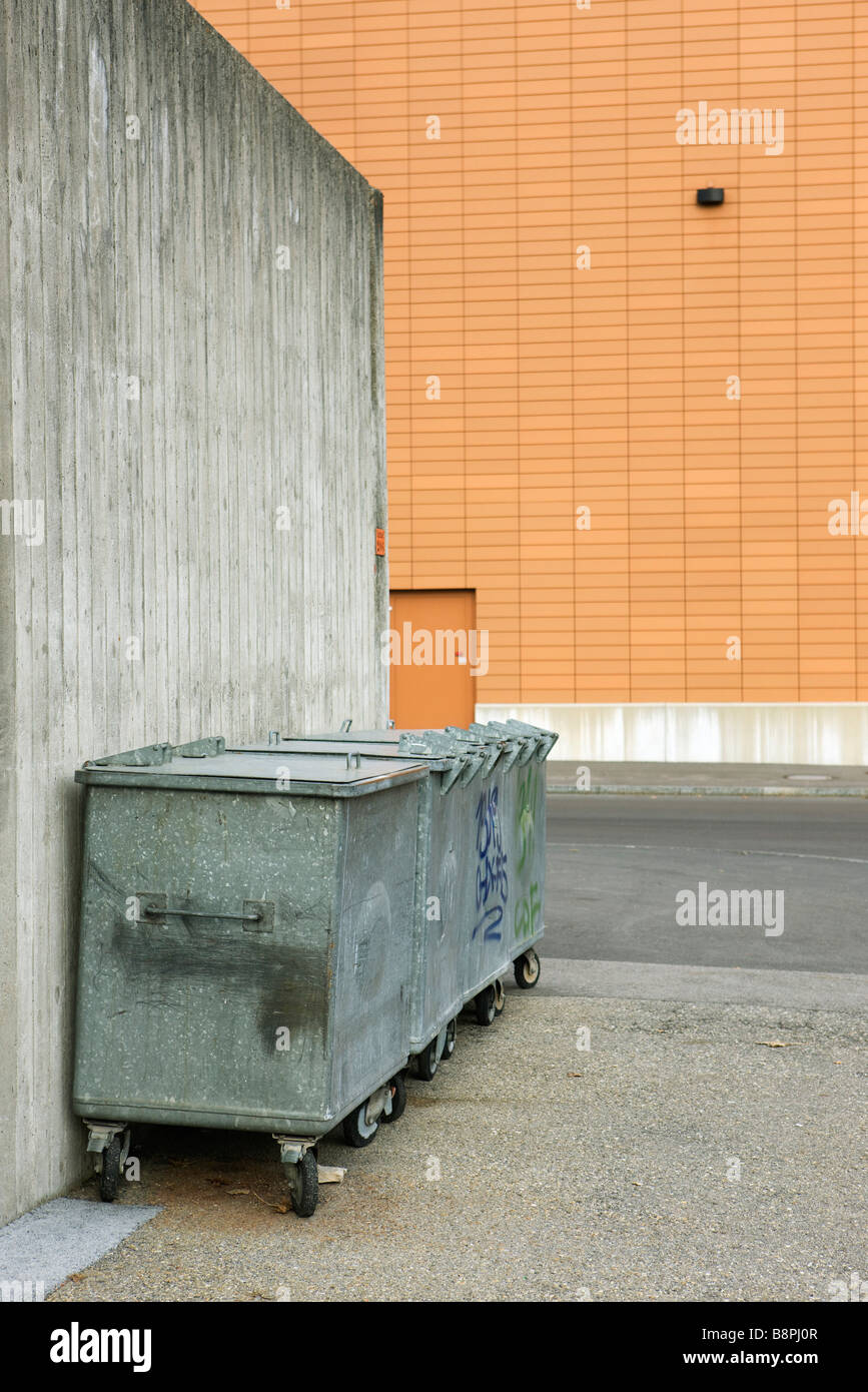 Trash bins in alleyway Stock Photo