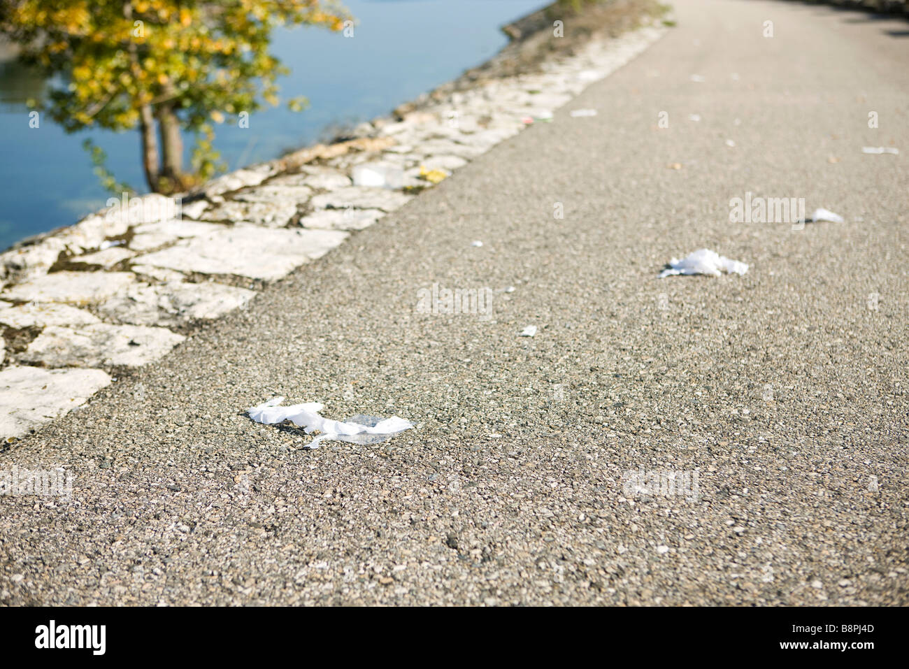Garbage scattered along road, closeup Stock Photo Alamy