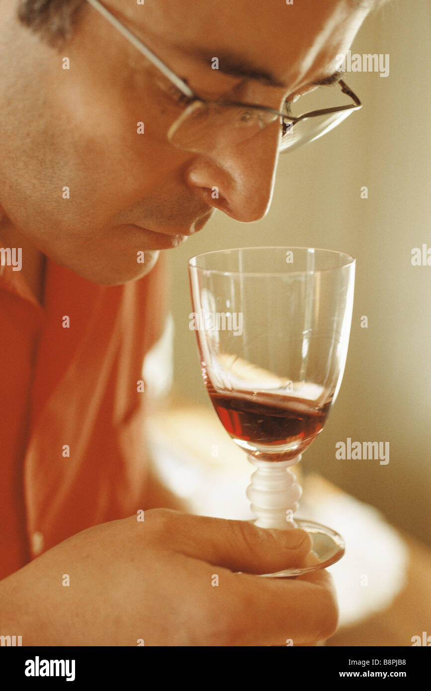 Man smelling red wine in wine glass Stock Photo - Alamy