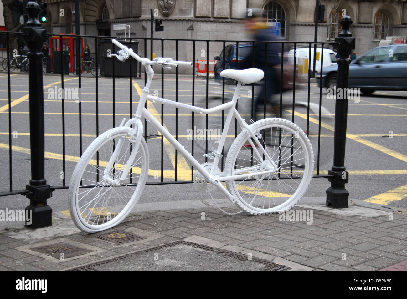 A bicycle flashes past a white bicycle art display (by St.Martins College Art & Design) close to Holborn Underground station. Stock Photo