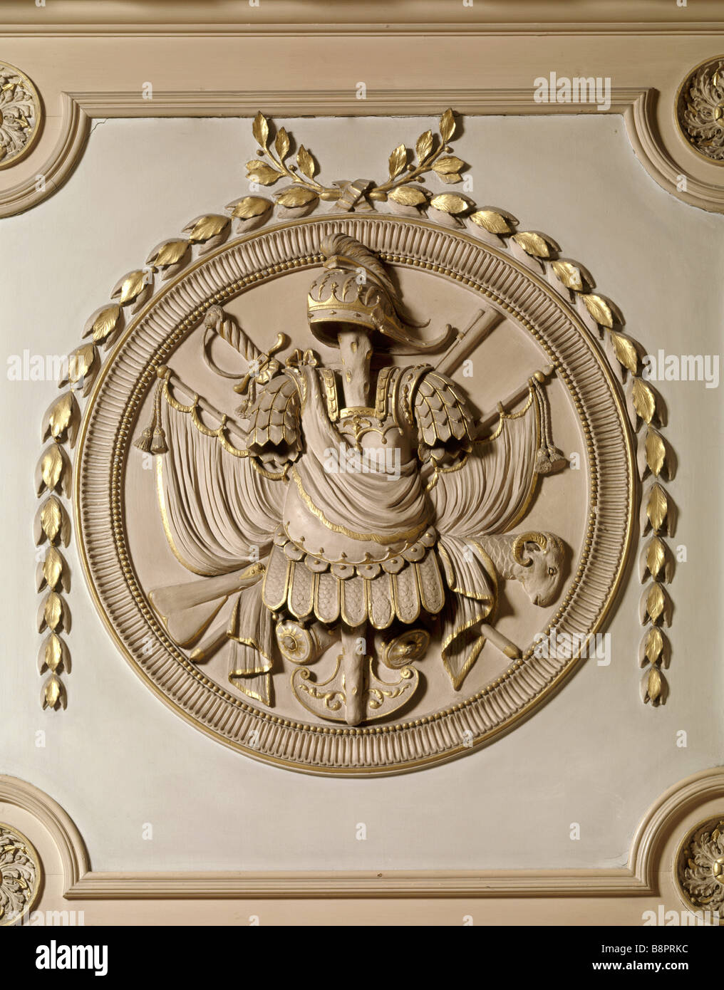 A detail of armorial trophy in roundel above the door in the Marble Hall Each roundel is draped with a swag of husks Stock Photo