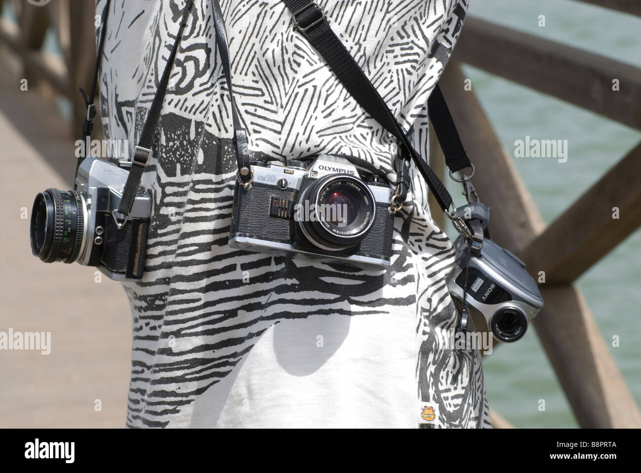 cameras on  local african photographer hips waiting for tourists in senegal Joal fadiouth Stock Photo