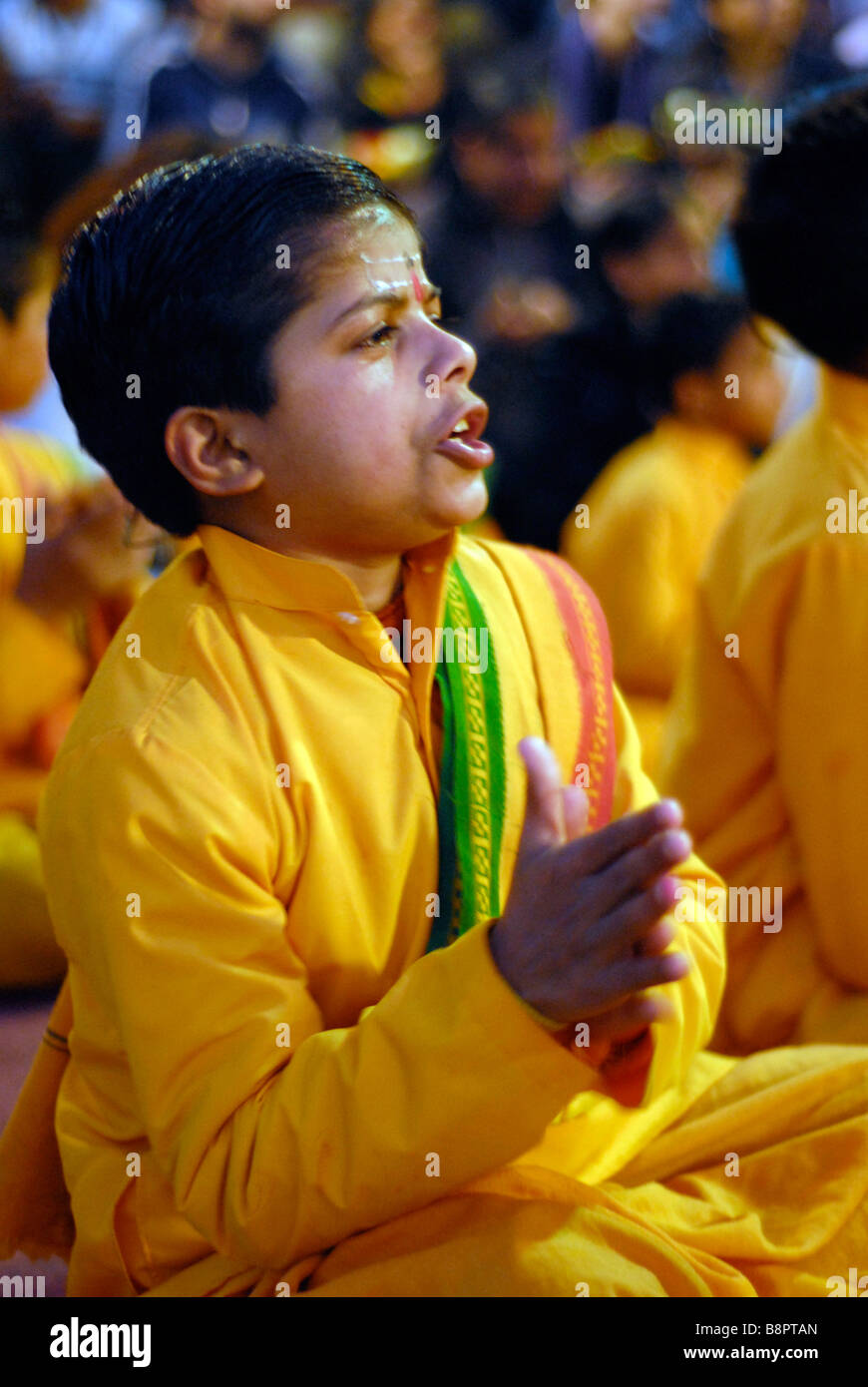 A boy singing prayers during the Ganga Aarti. Rishikesh, Uttaranchal, India Stock Photo