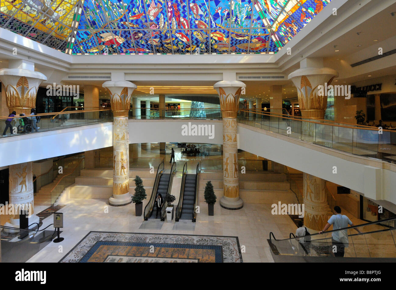 Dubai Wafi shopping mall building interior with Egyptian pyramid style stained glass roof above escalator hallway United Arab Emirates UAE Stock Photo