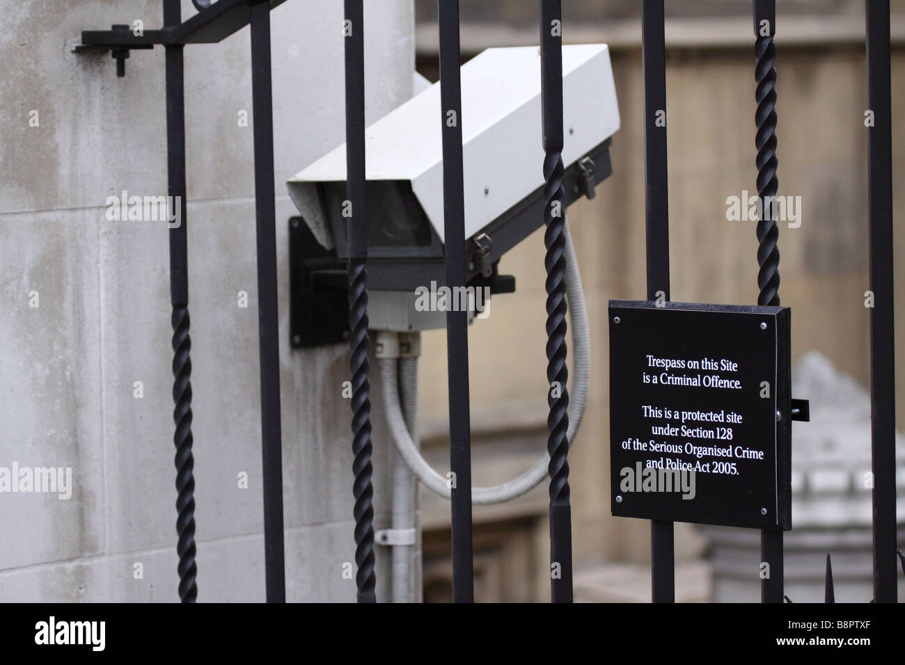 CCTV camera and security notice behind bars at the Palace of