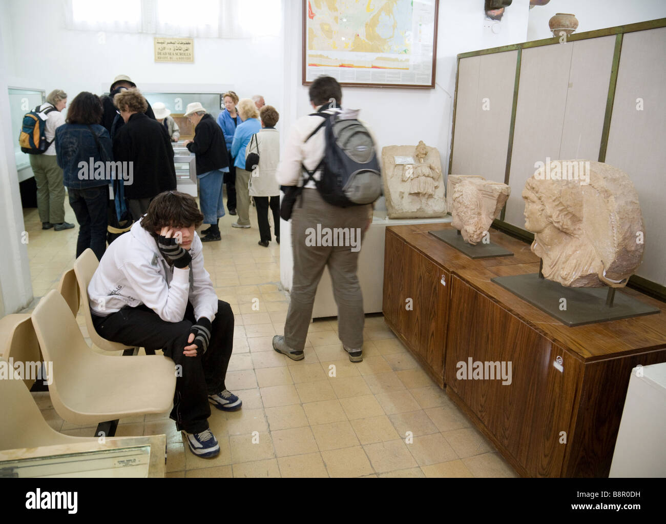 A Bored teenager in the Jordan Museum of Archaeology, Amman, Jordan Stock Photo