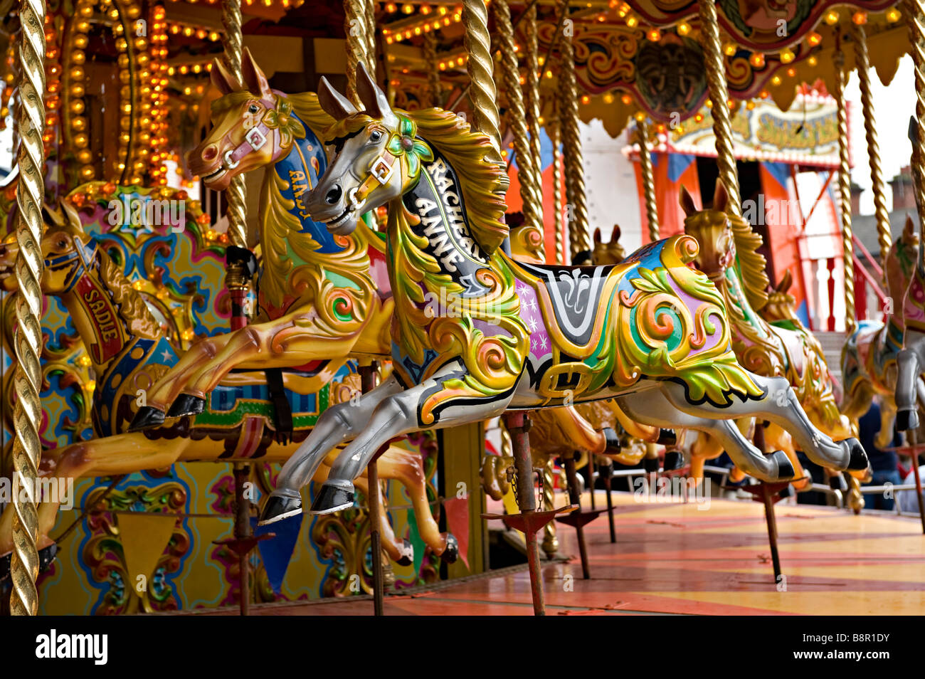Colourful carousel horses on a merry-go-round Stock Photo