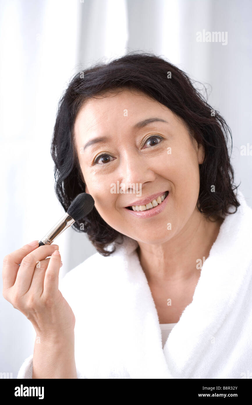 Woman using up brush smiling hi-res stock photography and images - Alamy