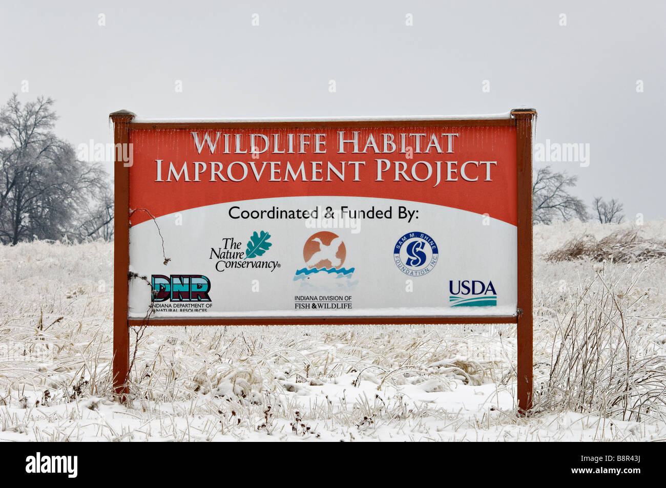 Wildlife Habitat Improvement Project Sign in Snow Covered Field in Floyd County Indiana Stock Photo