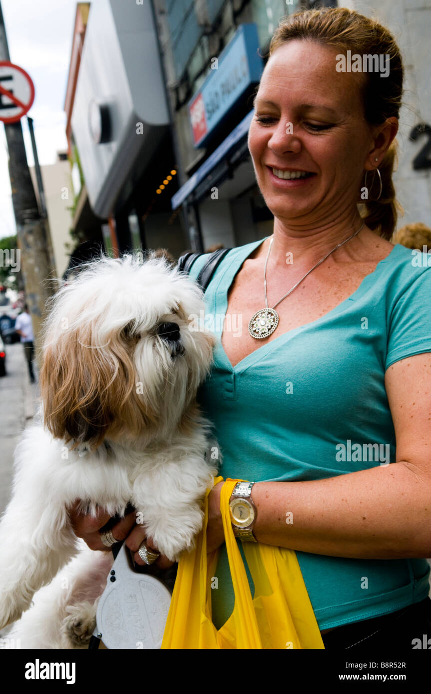 Walking with her pet dog in the streets of Sao Paulo, Brazil Stock