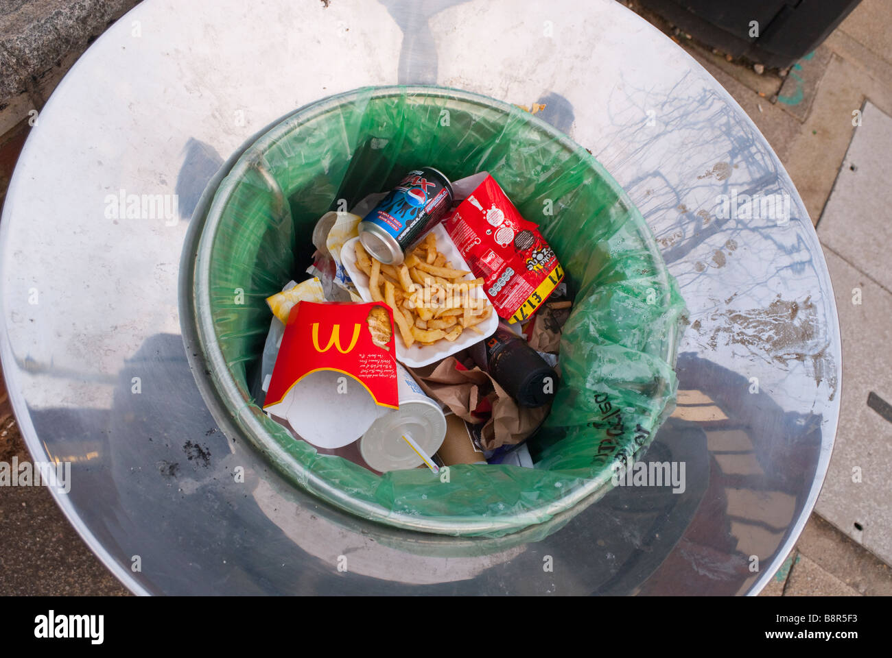 Rubbish bin with litter and trash inside it Stock Photo