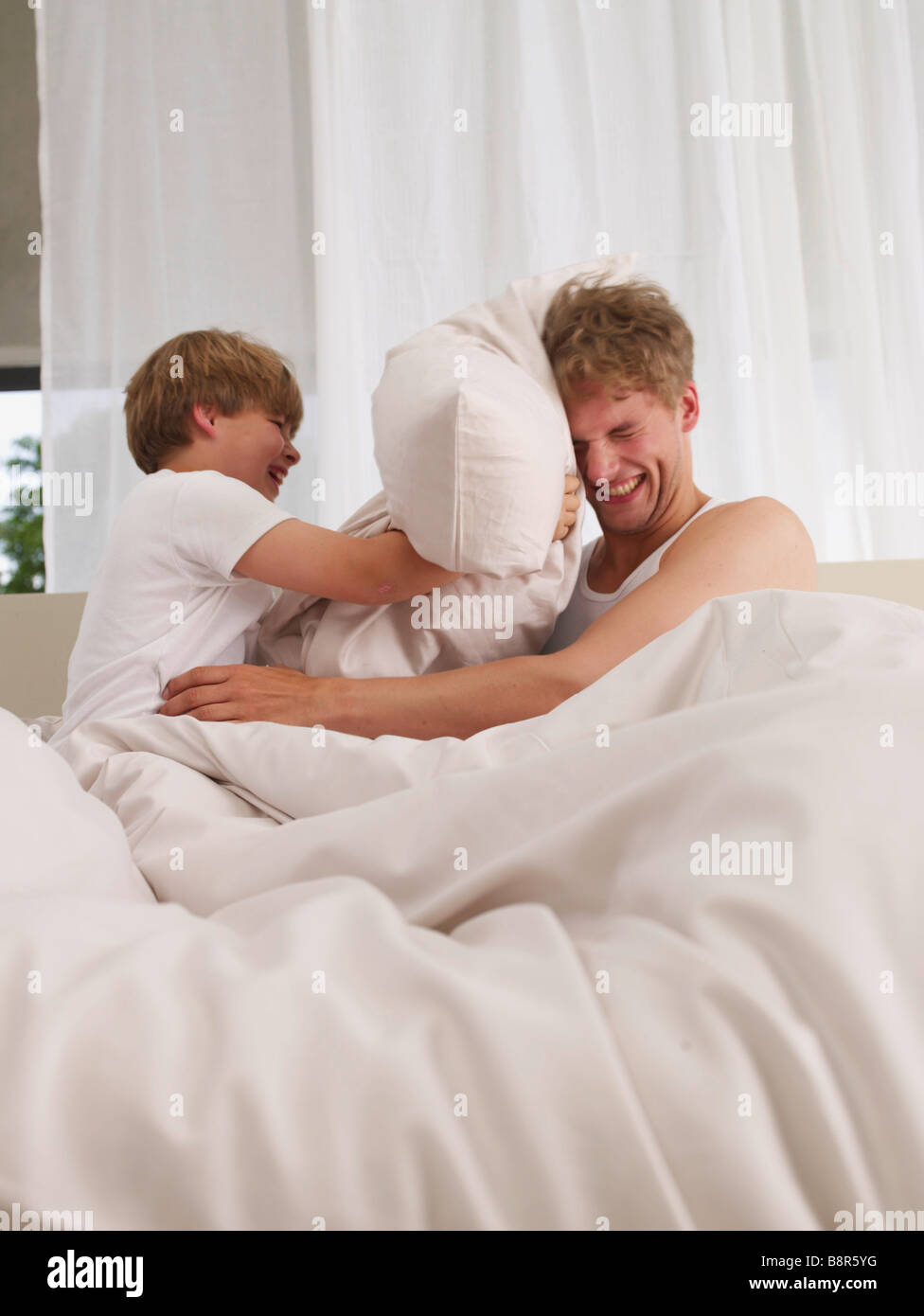 father and son's pillow fight Stock Photo