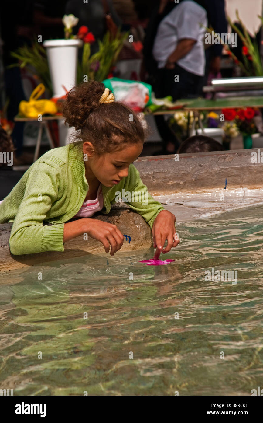 A young girl playing in a fountain Stock Photo - Alamy