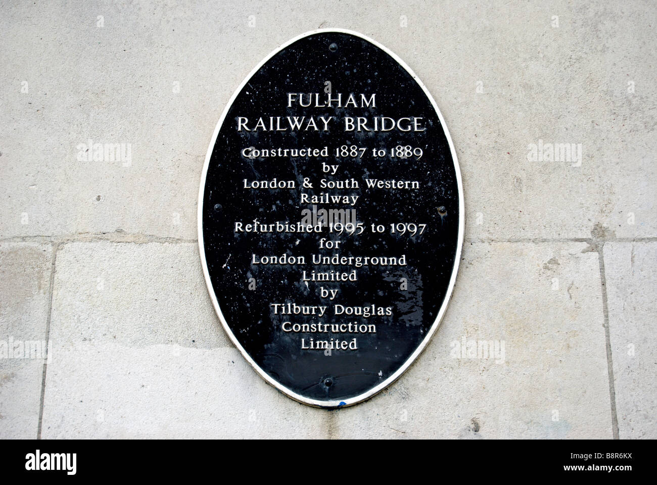 plaque on fulham railway bridge, crossing the river thames in london, detailing construction and refurbishment details Stock Photo