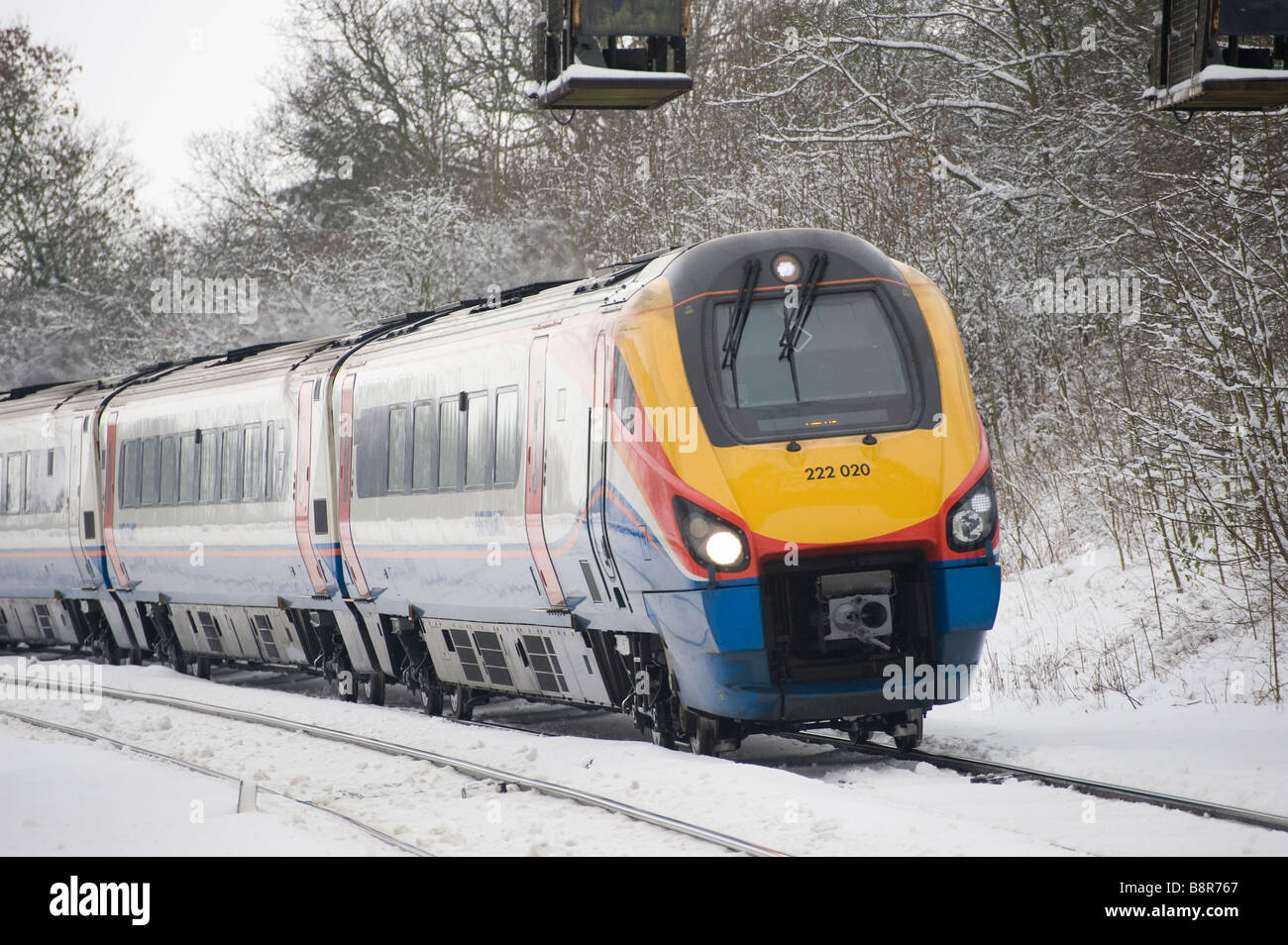 Class 222 Meridian train in East Midlands Trains livery travelling through snow in the Leicestershire countryside England Stock Photo