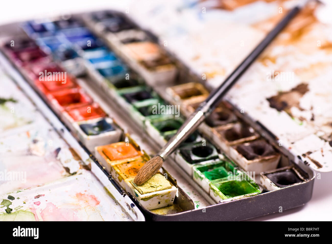 A well used set of watercolors with a brush Stock Photo