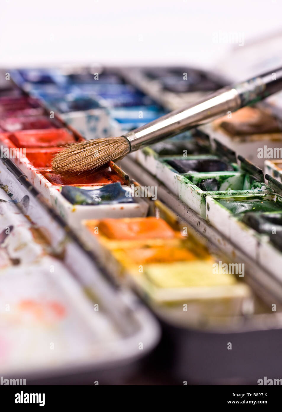 A well used set of watercolors with a brush Stock Photo