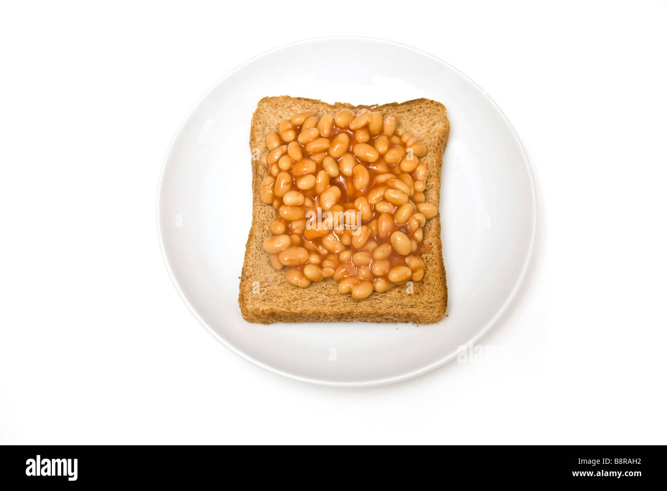 Plate of baked beans on toast isolated on a white studio background Stock Photo