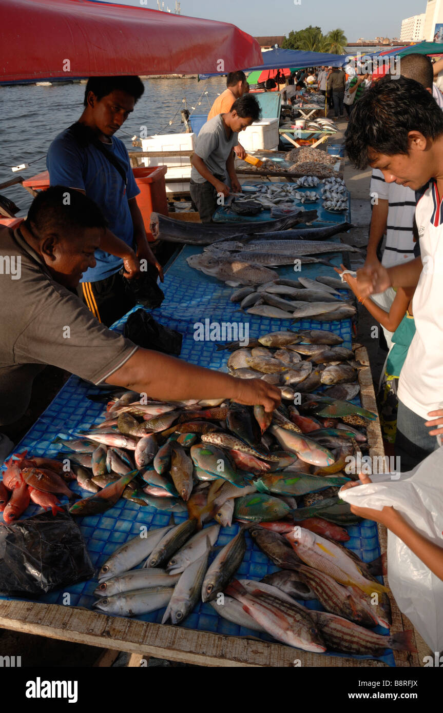 Customers and vendors selling and buying fish fish market waterfront