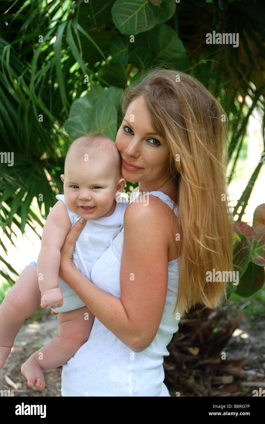 Young mother holding son up looking at camera Stock Photo