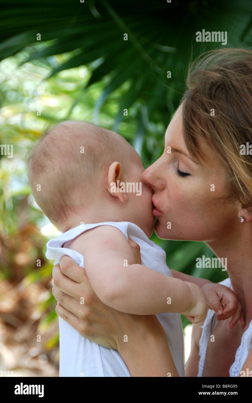 Young mother kissing young baby Stock Photo