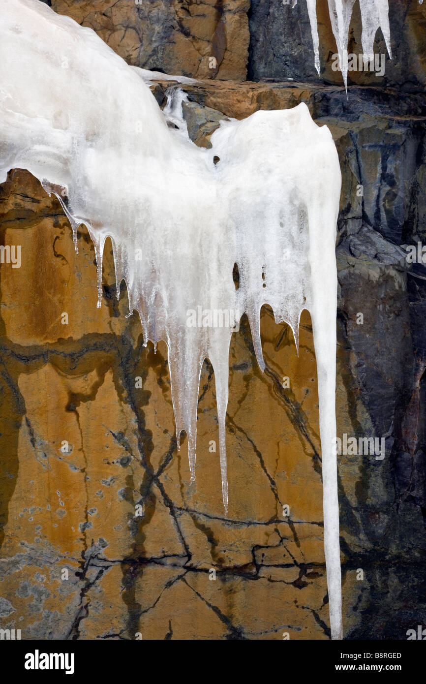 Large icicles hang from the roadside cliffs along The Million Dollar Highway, western Colorado, Colorado Stock Photo