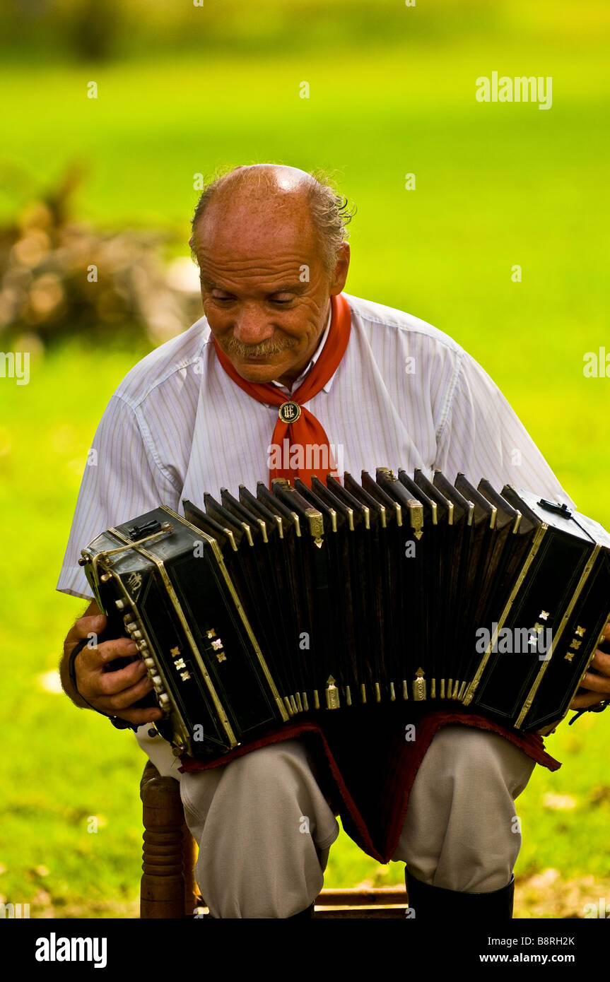 Argentinean gaucho man playing his accordion at a ranch Stock Photo