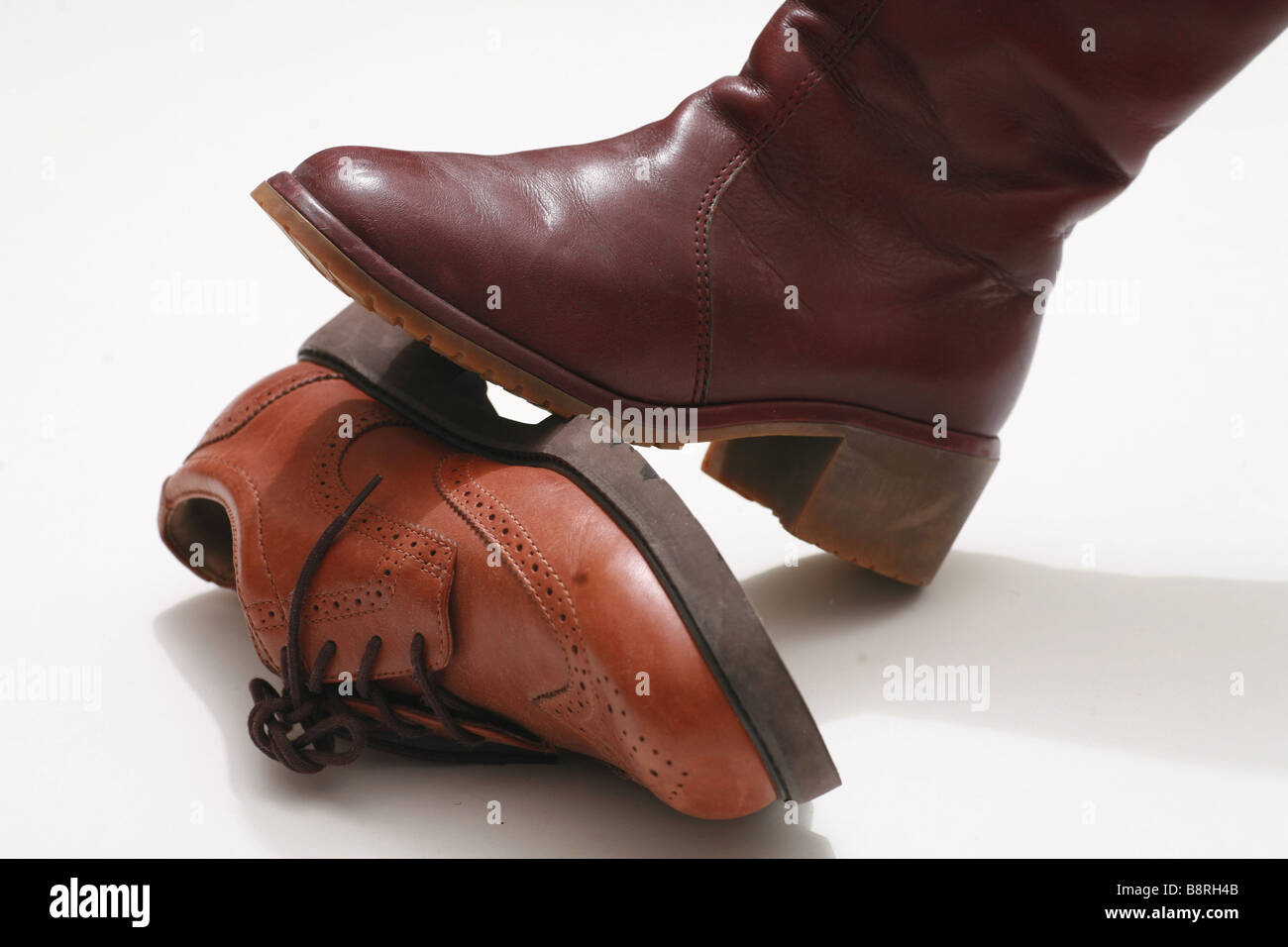 Close Up of a boot standing on another leather shoe Stock Photo