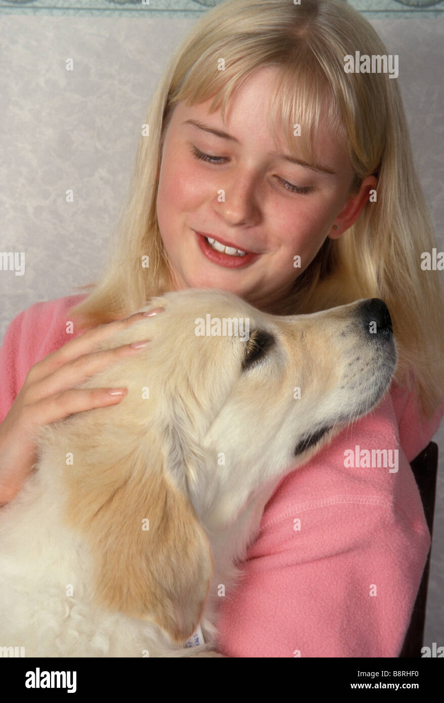 young girl playing with her golden retriever puppy Stock Photo - Alamy