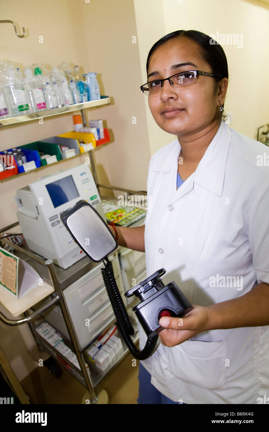Nurse checking a defibrillator machine on the ward of the Essar