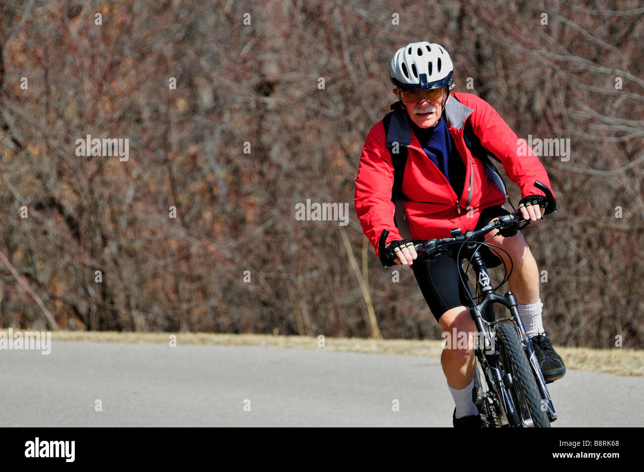 A senior man rides his bicycle on trails in Oklahoma City, Oklahoma, USA. Stock Photo