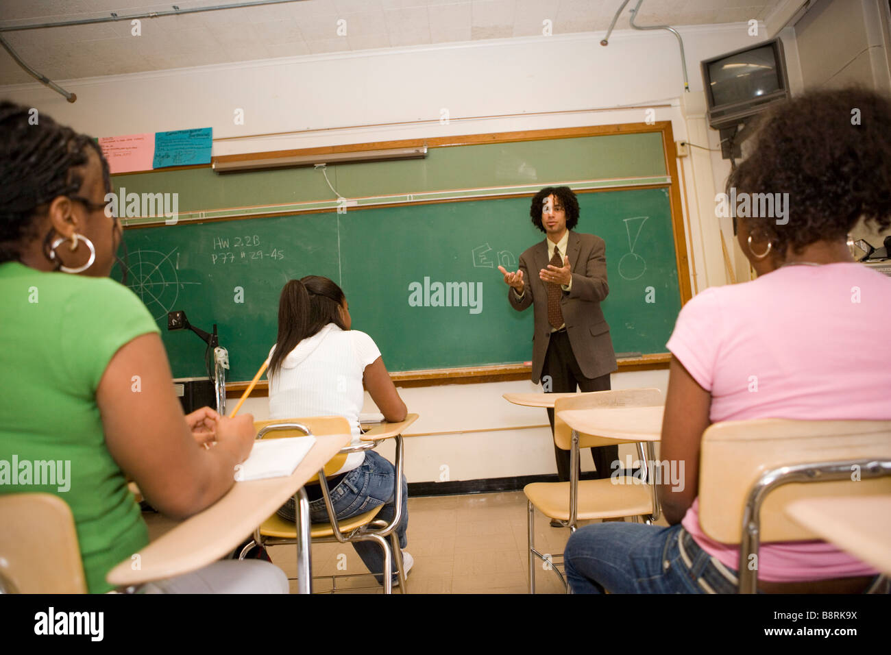 middle school teacher giving a lecture to teen students, classroom Stock Photo