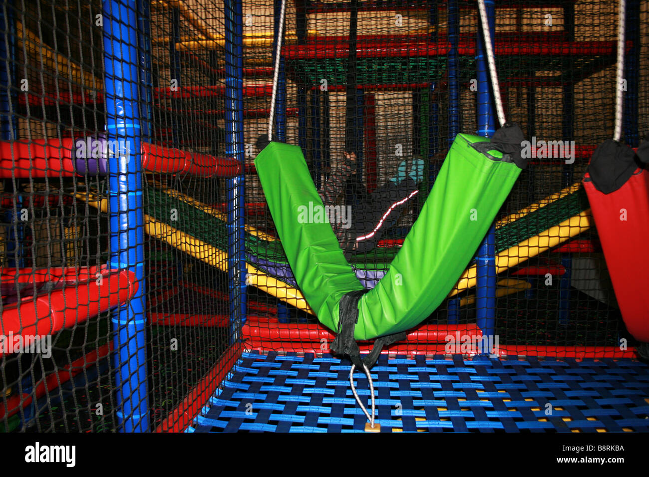 a foam swing hanging in an indoor play gym for kids Stock Photo Alamy