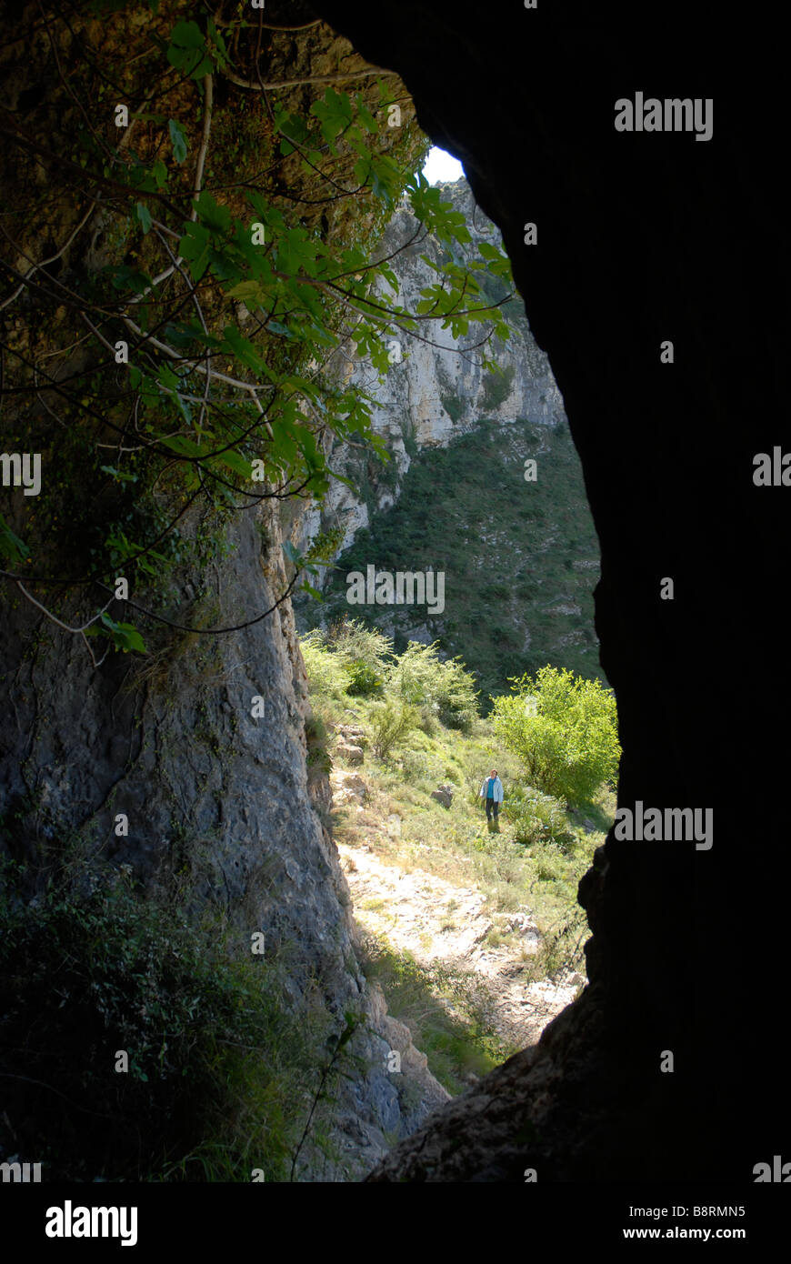 looking out of a cave, Vall de Laguart, Benimaurell, Alicante Province, Comunidad Valenciana, Spain Stock Photo