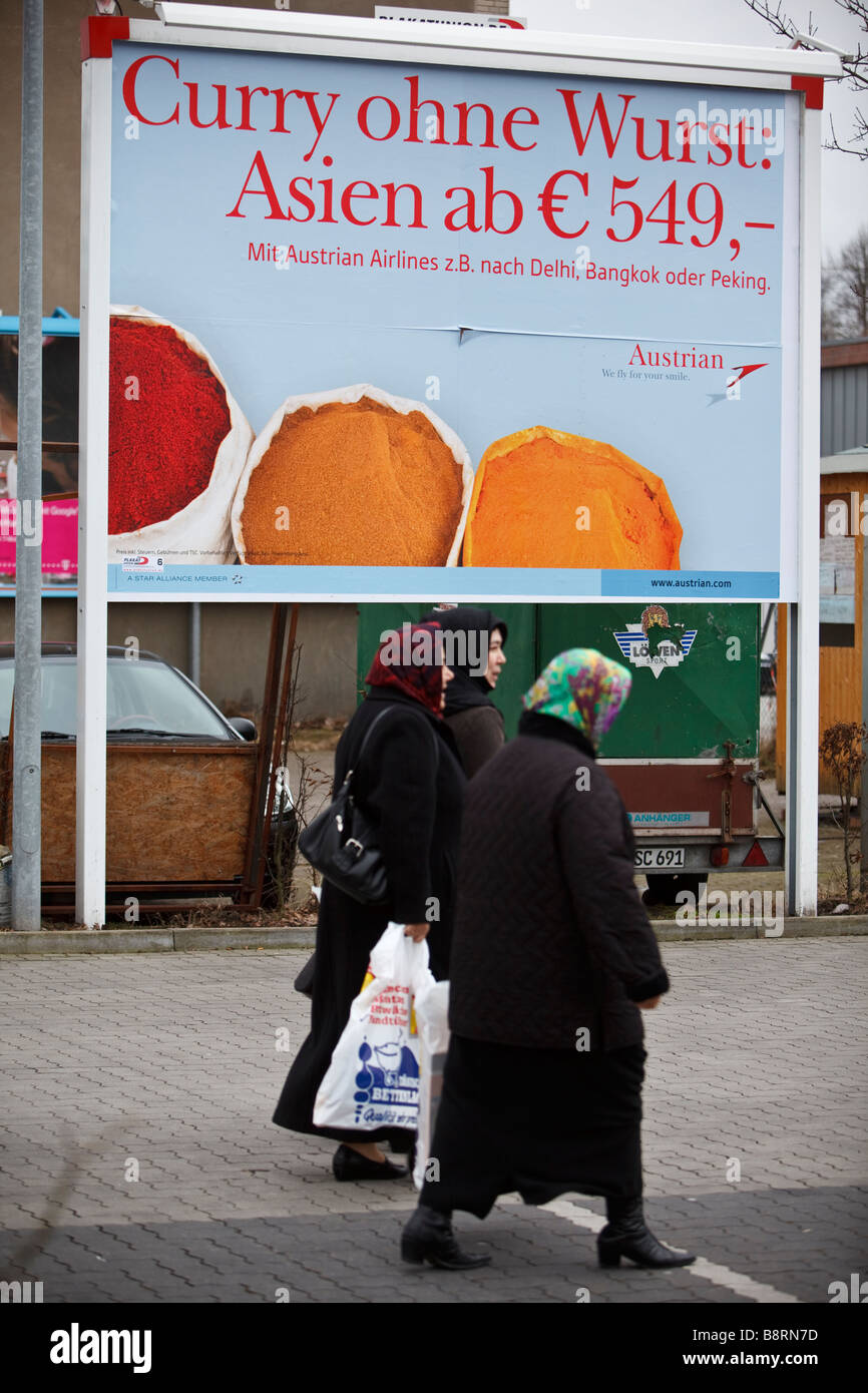 Group of muslem women wearing scarf crossing a street with plastic bags after shopping in Hamburg, Germany Stock Photo