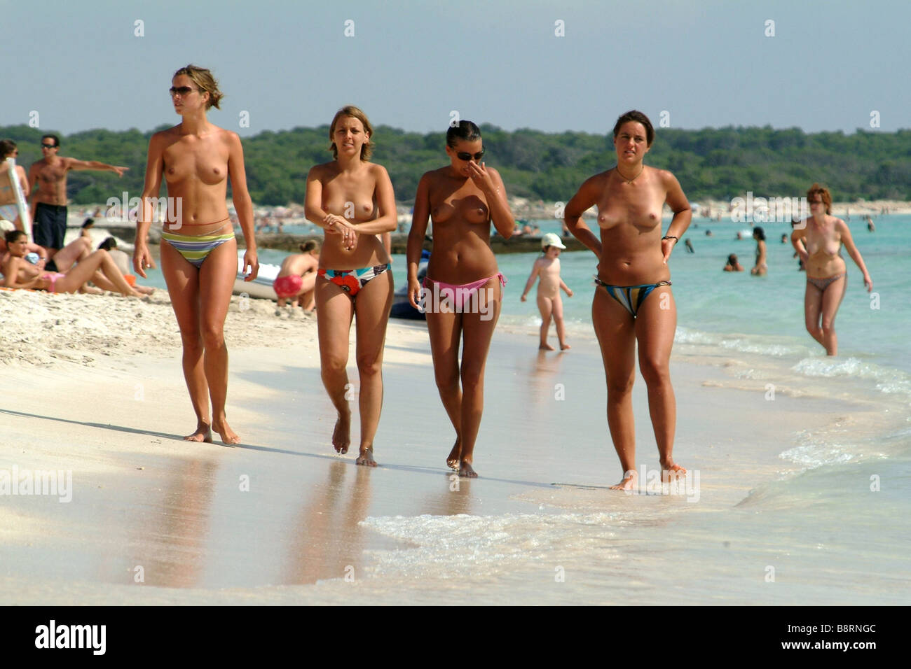 Nude women walking on beach