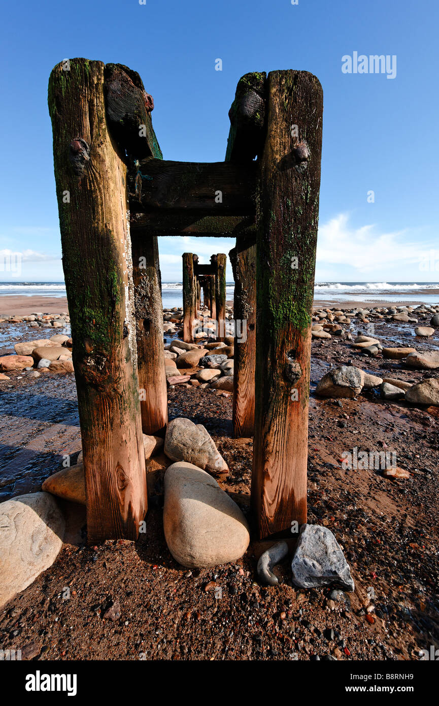 Abandoned pipeline supports on beach at Cambois Stock Photo