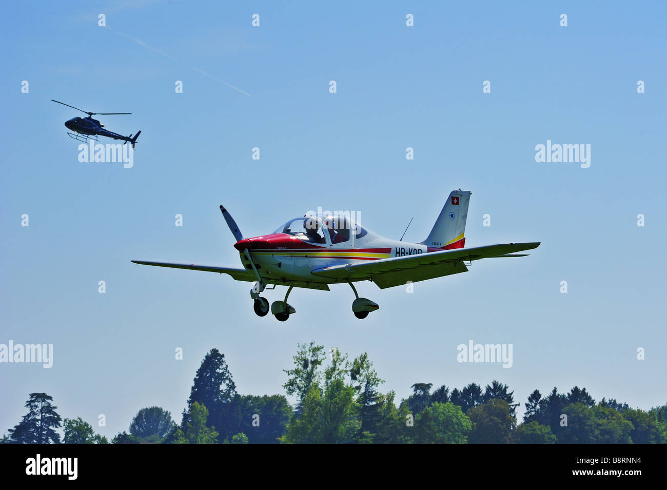 A light aircraft on inal approach, flaps down. Space for text in the sky. Stock Photo