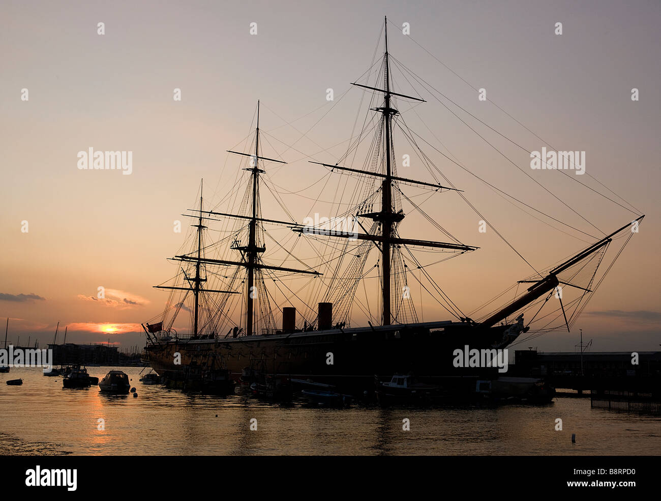 HMS Warrior 1860 at dusk on Portsmouth's Historic Harbour Waterfront Stock Photo