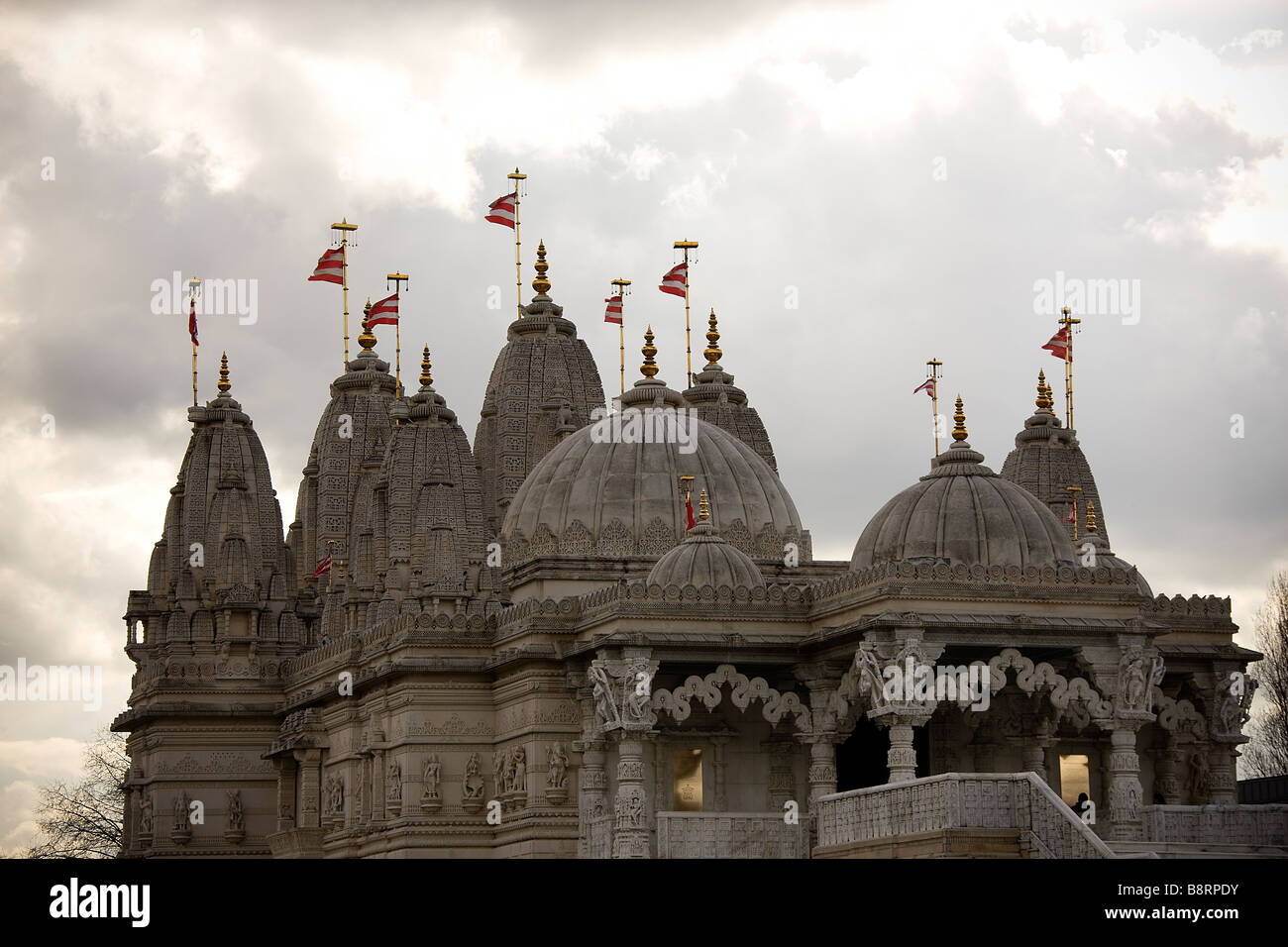 Flags and dome roofs on top of the BAPS Shri Swaminarayan Mandir London Neasden Temple Stock Photo