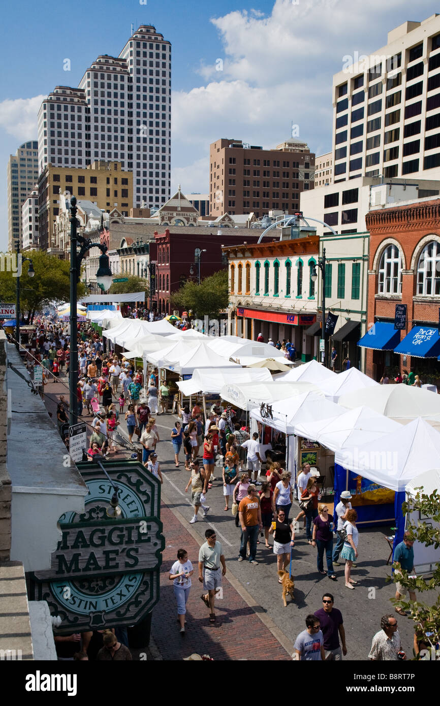 People walk down 6th street during the Pecan Street Festival in Austin, Texas Stock Photo