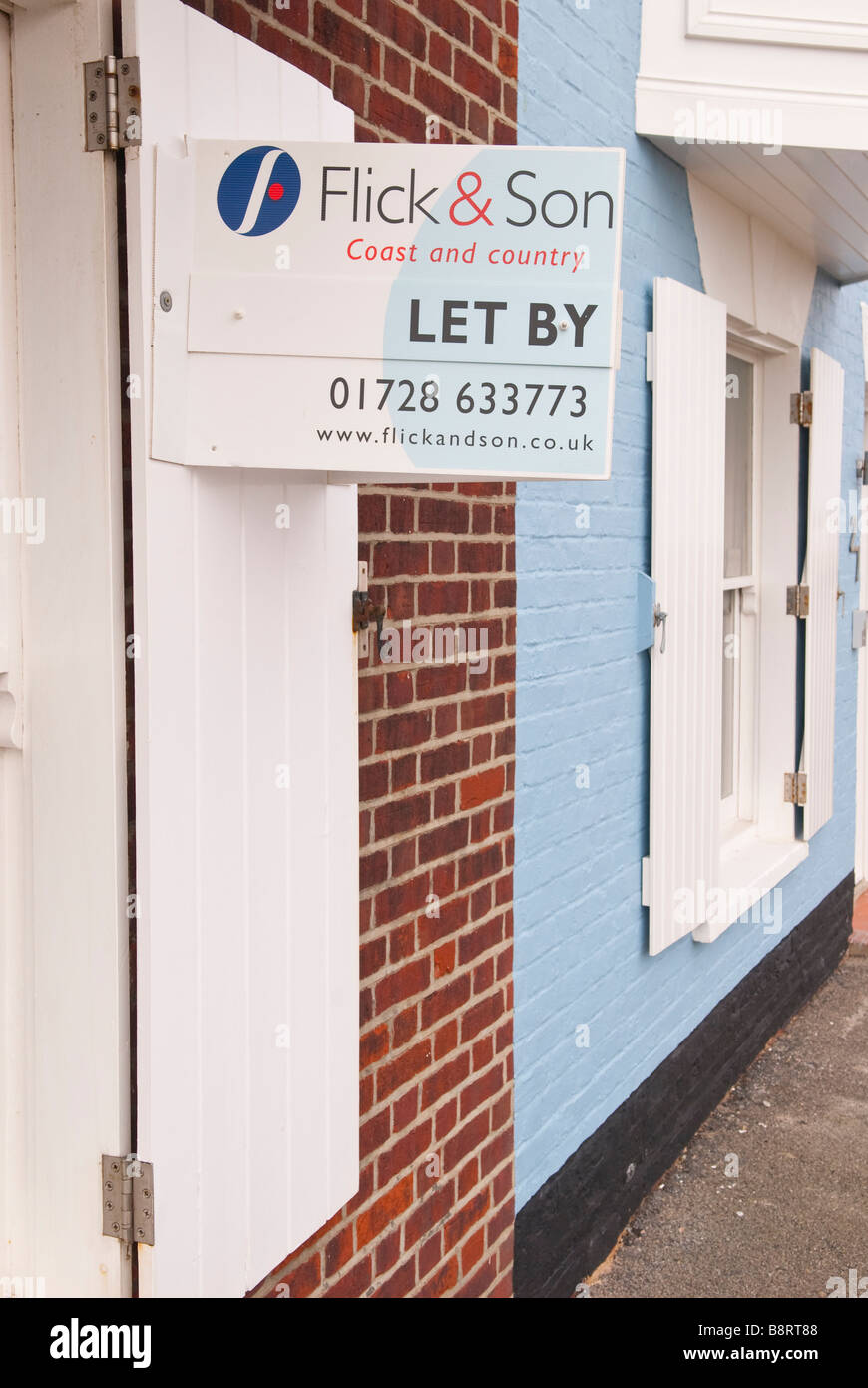 A for sale sign by Flick & son coast and country the estate agent on a