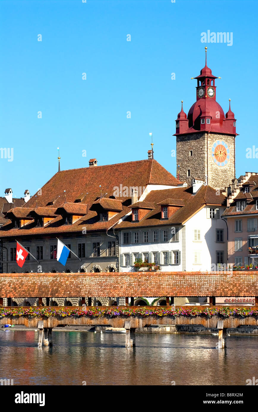Historical old town and the Chapel Bridge (Kapellbruecke) in front of the clock tower of the Lucerne town hall Stock Photo